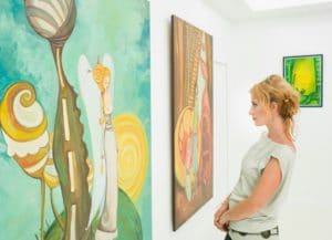 Woman viewing artwork at the Rappahannock Art League in Kilmarnock